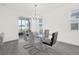 Bright dining area with a glass table, modern chairs, and sliding doors to the outdoor space at 2993 Irish Peach Dr, Winter Garden, FL 34787