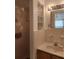 Bathroom featuring a glass block window, sink and vanity, and a shower at 3112 Eleuthera Ln, Orlando, FL 32827