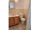 Bathroom featuring a wood vanity, toilet, and sink, all illuminated by natural light at 3112 Eleuthera Ln, Orlando, FL 32827