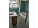 Retro bathroom featuring tiled walls, classic vanity, and a combined tub and shower at 3112 Eleuthera Ln, Orlando, FL 32827