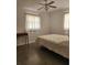 Bedroom featuring natural light from two windows, a bed, a desk, and speckled floors at 3112 Eleuthera Ln, Orlando, FL 32827