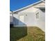 Exterior showcasing a side entrance and a window providing natural light at 3112 Eleuthera Ln, Orlando, FL 32827