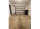 This garage includes concrete flooring and a garage door that is partially open at 3112 Eleuthera Ln, Orlando, FL 32827