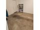 Storage room featuring a door, concrete floor and a black metal shelf unit at 3112 Eleuthera Ln, Orlando, FL 32827