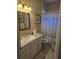 Bathroom featuring a white vanity, a shower curtain with sea life, and ceramic tile flooring at 318 Mohave Ter, Lake Mary, FL 32746