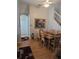 Dining room featuring a wooden table, chairs, a large painting, and hardwood floors at 318 Mohave Ter, Lake Mary, FL 32746