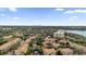 Aerial view of a residential community surrounded by trees and a distant lake at 3338 Robert Trent Jones Dr # 20804, Orlando, FL 32835