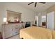 Bedroom featuring neutral walls, ceiling fan, and door leading to bathroom at 3338 Robert Trent Jones Dr # 20804, Orlando, FL 32835