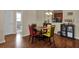 A dining area features a round glass table with colorful chairs, next to a cabinet and kitchen at 3338 Robert Trent Jones Dr # 20804, Orlando, FL 32835