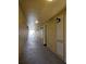 Well-lit hallway with wall-mounted sconces leading to various apartments at 3338 Robert Trent Jones Dr # 20804, Orlando, FL 32835