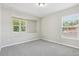 Bedroom with two windows letting in natural light and neutral walls and carpet at 3350 Pegaso Ave, New Smyrna Beach, FL 32168