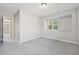 Bedroom with neutral walls and carpet and window letting in natural light at 3350 Pegaso Ave, New Smyrna Beach, FL 32168