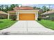 Exterior home featuring a well-manicured lawn, driveway, and a two-car garage at 3350 Pegaso Ave, New Smyrna Beach, FL 32168