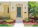 Close up of the home's entrance with manicured plants and a pathway leading to the front door at 3350 Pegaso Ave, New Smyrna Beach, FL 32168