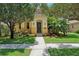 Inviting home featuring a well-manicured lawn, complemented by mature trees and vibrant landscaping at 3350 Pegaso Ave, New Smyrna Beach, FL 32168