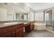 Main bathroom with double sink vanity, soaking tub, and tiled walk-in shower at 3350 Pegaso Ave, New Smyrna Beach, FL 32168