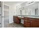 Double sink vanity in bathroom with tile flooring, large mirrors, and great lighting at 3350 Pegaso Ave, New Smyrna Beach, FL 32168