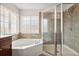 Soaking tub and glass enclosed shower in main bathroom with natural light at 3350 Pegaso Ave, New Smyrna Beach, FL 32168