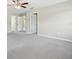 Spacious main bedroom with neutral walls and carpet and multiple doors at 3350 Pegaso Ave, New Smyrna Beach, FL 32168