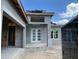 Close-up of the front of the house, showing double door entry and construction progress at 336 Caladium Ave, Lake Alfred, FL 33850