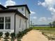 Side view of the home, complemented by vibrant green landscaping at 336 Caladium Ave, Lake Alfred, FL 33850