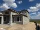 Exterior view of a two-story home with a neutral stucco facade and modern window design at 336 Caladium Ave, Lake Alfred, FL 33850