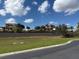 A glimpse of a perfectly manicured lawn with luxurious homes built in the distance on the horizon at 336 Caladium Ave, Lake Alfred, FL 33850