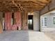 Unfinished interior view showing the open floorplan with concrete block walls ready for insulation at 336 Caladium Ave, Lake Alfred, FL 33850