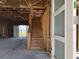 Unfinished interior view showing the open floorplan and staircase leading to the second floor at 336 Caladium Ave, Lake Alfred, FL 33850