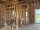 Unfinished interior view of framed rooms and window openings overlooking the lake at 336 Caladium Ave, Lake Alfred, FL 33850