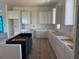 Bright kitchen with white upper cabinets, black island, and expansive countertops, perfect for cooking and entertaining at 336 Caladium Ave, Lake Alfred, FL 33850