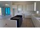 Unfinished kitchen showcasing custom black island installation complementing the bright white cabinetry and modern layout at 336 Caladium Ave, Lake Alfred, FL 33850