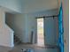 Open-concept living area features a staircase, barn door, and large windows, creating a bright and inviting space at 336 Caladium Ave, Lake Alfred, FL 33850