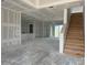 Open living area featuring a staircase and sliding glass doors, ready for flooring and paint at 336 Caladium Ave, Lake Alfred, FL 33850