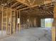 Spacious living room during the initial phases of construction with a large window view at 336 Caladium Ave, Lake Alfred, FL 33850