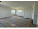 Large living room with tray ceiling, flooded with natural light from multiple windows, showcasing a bright and airy atmosphere at 336 Caladium Ave, Lake Alfred, FL 33850