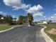 A smooth blacktop road winds past a tall palm tree in a upscale community of new homes at 336 Caladium Ave, Lake Alfred, FL 33850