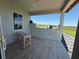 Covered patio with tile floors provides stunning lake views, perfect for relaxation at 336 Caladium Ave, Lake Alfred, FL 33850