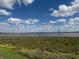 Stunning views of the water from this lot with clear blue skies dotted with puffy white clouds overhead at 336 Caladium Ave, Lake Alfred, FL 33850