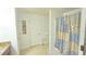 Bathroom with a shower featuring a tan and blue patterned shower curtain at 3810 Arboreal Ct, Deland, FL 32724