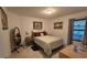 Bedroom featuring a comfortable bed, accent mirror, and natural lighting at 3810 Arboreal Ct, Deland, FL 32724