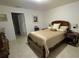 Comfortable bedroom featuring a wood bed frame and neutral color scheme at 3810 Arboreal Ct, Deland, FL 32724