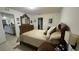 Comfortable bedroom featuring neutral walls, tile floors, wooden dresser, and soft lighting at 3810 Arboreal Ct, Deland, FL 32724