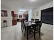 Dining area with modern table, seating for six, tile floors, and seamlessly connecting to the kitchen at 3810 Arboreal Ct, Deland, FL 32724