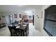 Dining area with dark table set for four, tile floors, and bright space that connects to the kitchen at 3810 Arboreal Ct, Deland, FL 32724