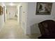 Bright hallway featuring neutral walls, tile floors, framed artwork, and an entryway closet at 3810 Arboreal Ct, Deland, FL 32724