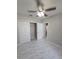 Bedroom featuring a ceiling fan, closet, and neutral paint, with tile flooring at 3869 Carrick Bend, Kissimmee, FL 34746