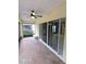 Enclosed patio area with a ceiling fan and brick flooring providing an outdoor space at 3869 Carrick Bend, Kissimmee, FL 34746