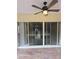 Enclosed patio area with brick flooring and sliding glass doors, perfect for outdoor living at 3869 Carrick Bend, Kissimmee, FL 34746