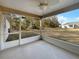 Relaxing screened porch featuring a ceiling fan, providing a comfortable outdoor living space with views of the backyard at 3891 Sw 130Th Loop, Ocala, FL 34473